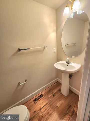 a bathroom with a sink a mirror and toilet