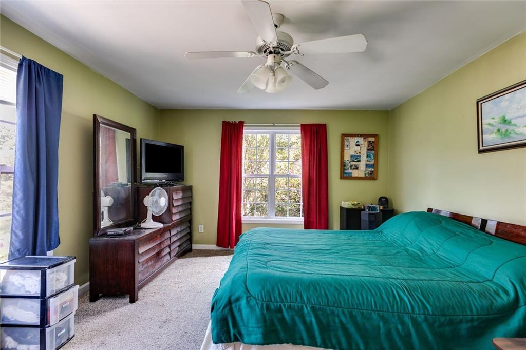 80 Jacob Trail Rockmart, GA 30153 - Photo 11 of 24 a spacious bedroom with a bed and a chandelier