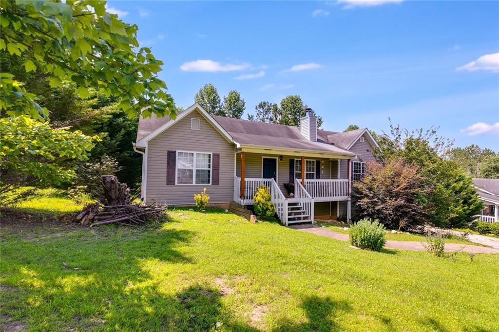80 Jacob Trail Rockmart, GA 30153 - Photo 2 of 24 a front view of a house with garden and porch