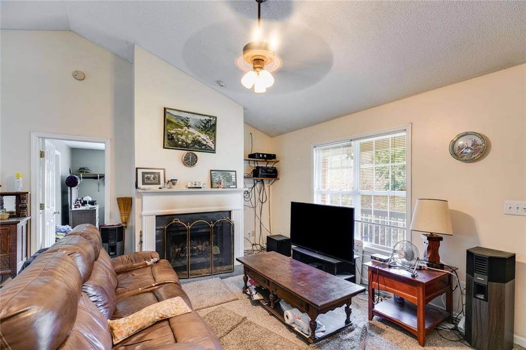 80 Jacob Trail Rockmart, GA 30153 - Photo 5 of 24 a living room with furniture a flat screen tv and a fireplace