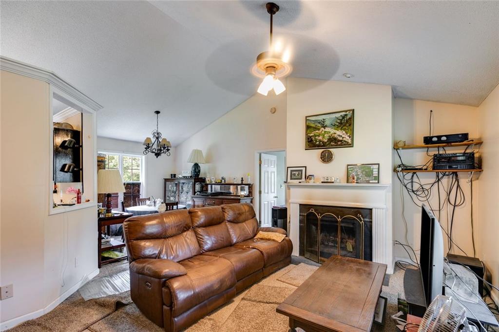 80 Jacob Trail Rockmart, GA 30153 - Photo 6 of 24 a living room with furniture a fireplace and a flat screen tv