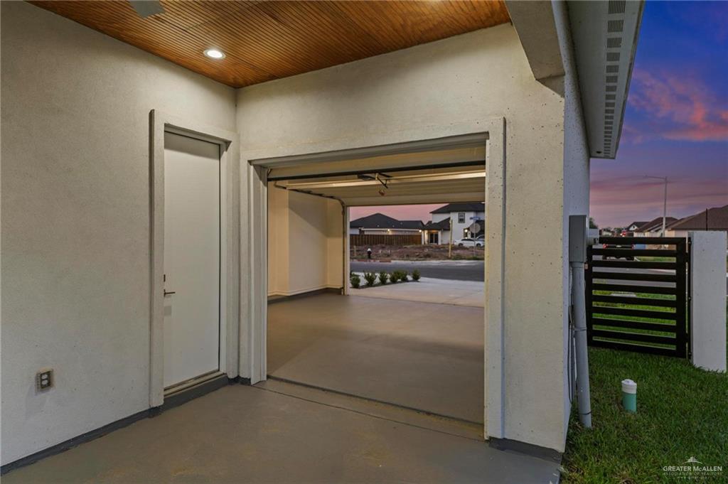 2716 East Conroe Road Edinburg, TX 78542 - Photo 25 of 31 Garage featuring wood ceiling, recessed lighting, and a textured wall