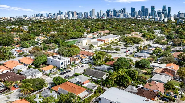 an aerial view of residential houses with city view