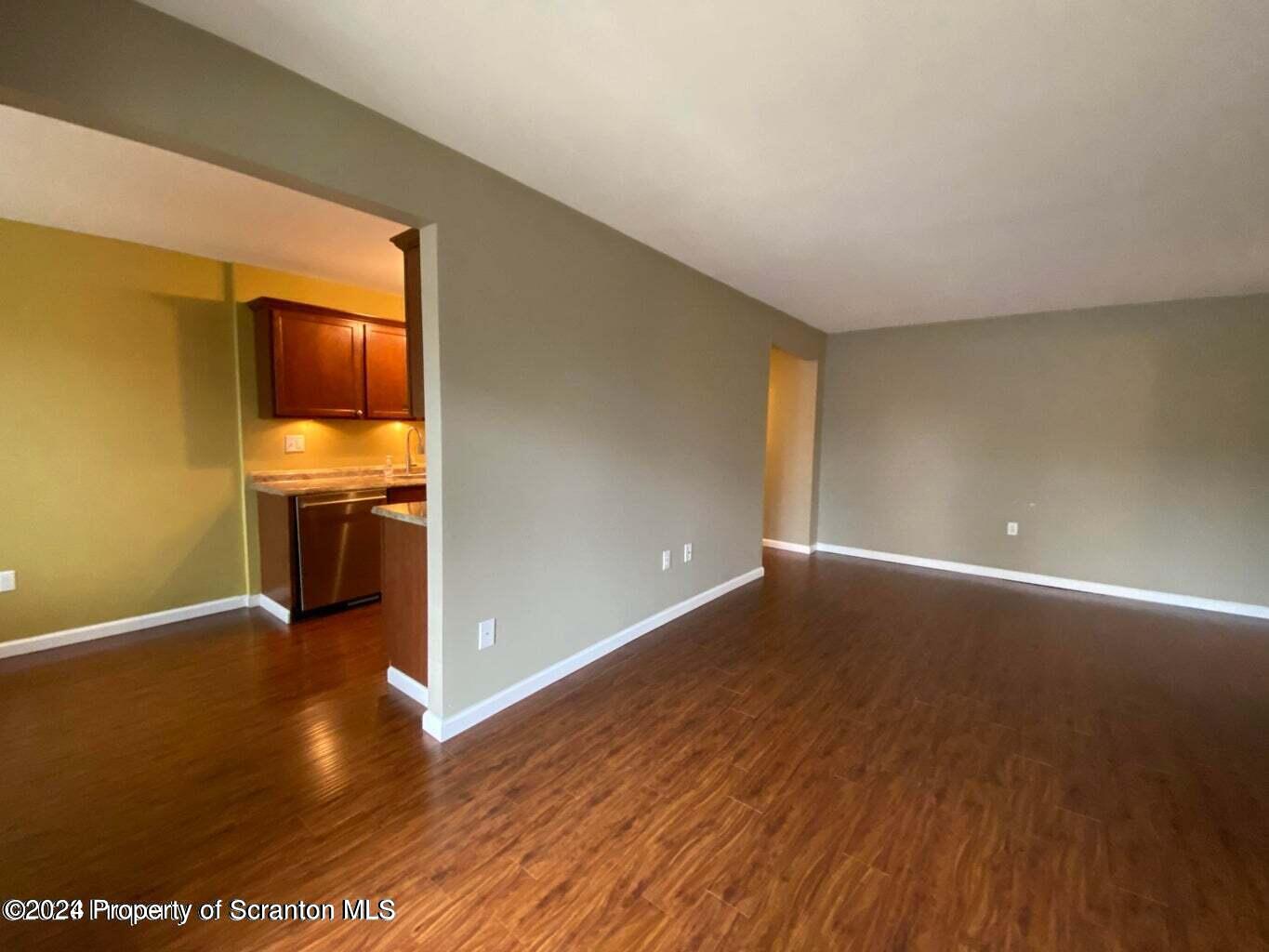 1702 Summit Pointe Scranton, PA 18508 - Photo 12 of 30 a view of a room with wooden floor and a kitchen