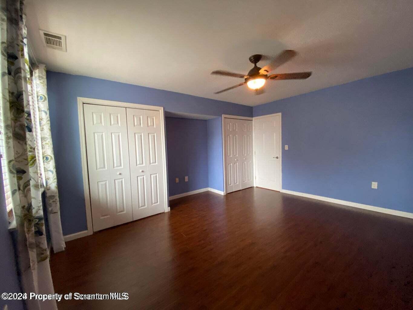 1702 Summit Pointe Scranton, PA 18508 - Photo 17 of 30 a view of an empty room with wooden floor and windows