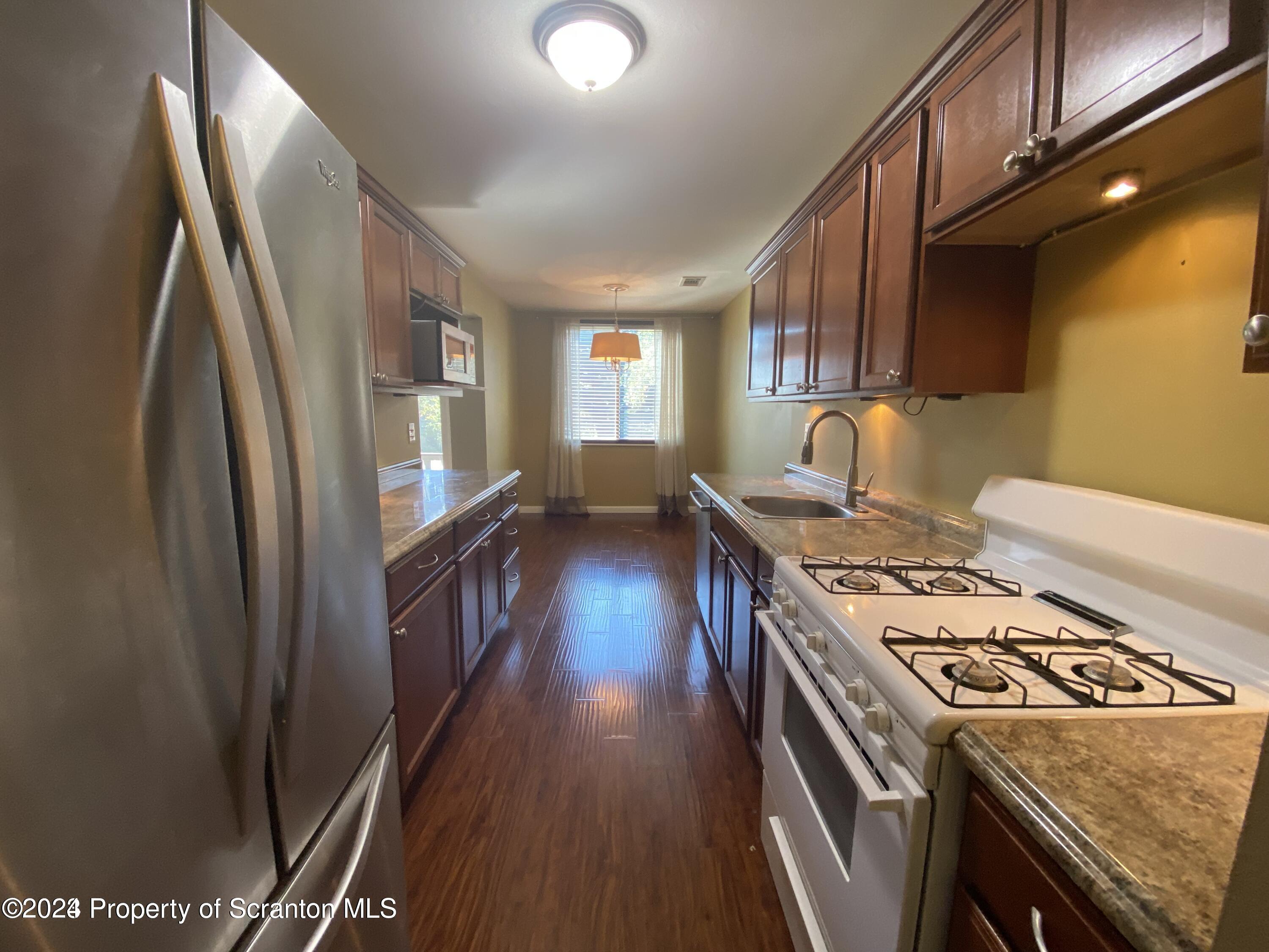 1702 Summit Pointe Scranton, PA 18508 - Photo 5 of 30 a kitchen with a stove a refrigerator and a stove