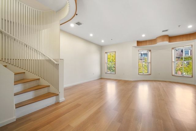 a view of an entryway with wooden floor