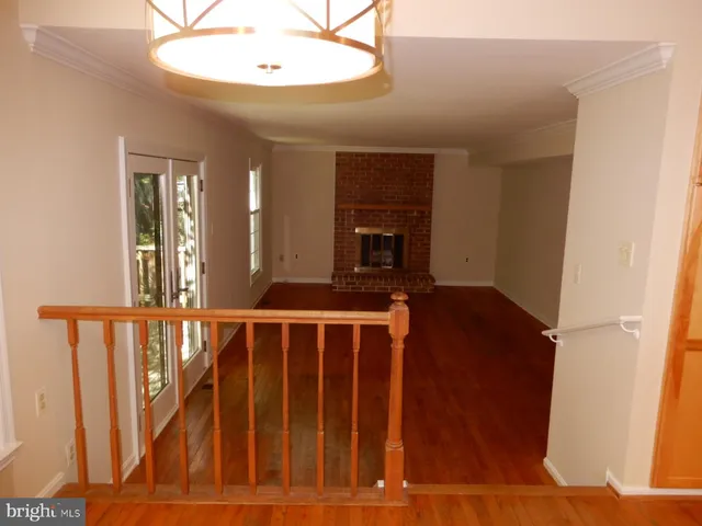 a view of wooden floor and a fireplace in a room