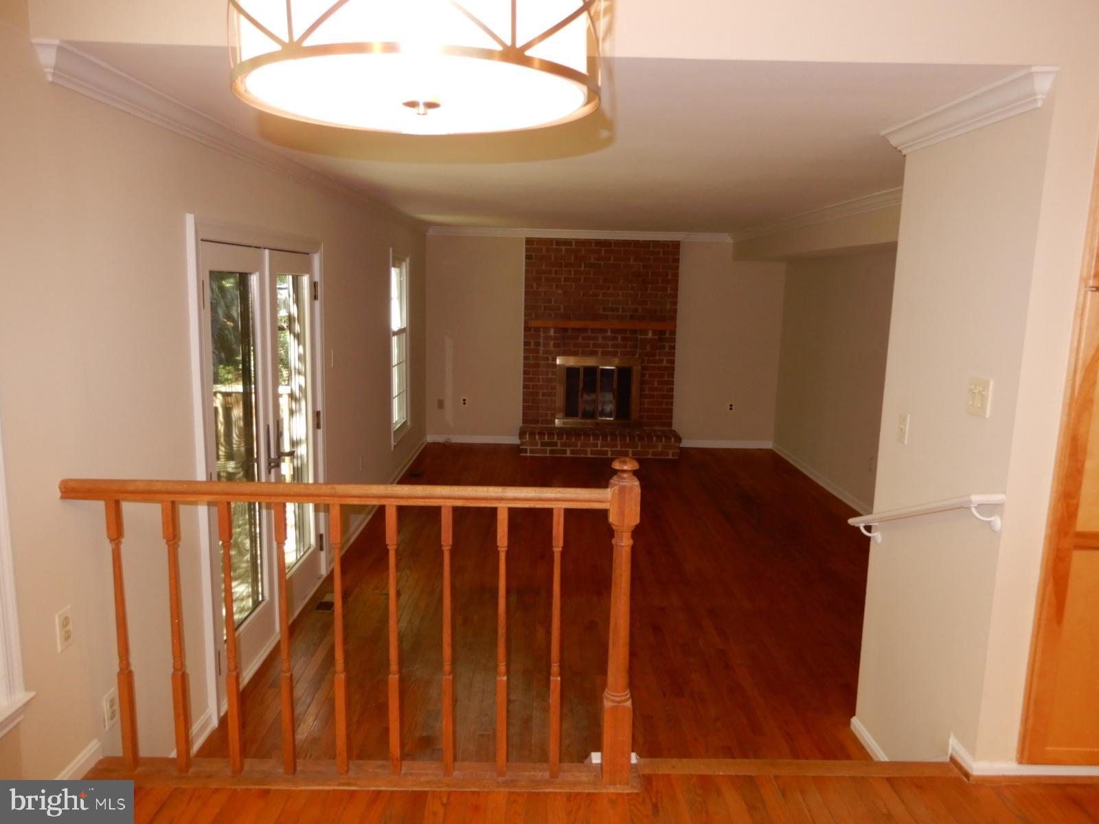 7014 Maple Tree Lane Springfield, VA 22152 - Photo 13 of 56 a view of wooden floor and a fireplace in a room