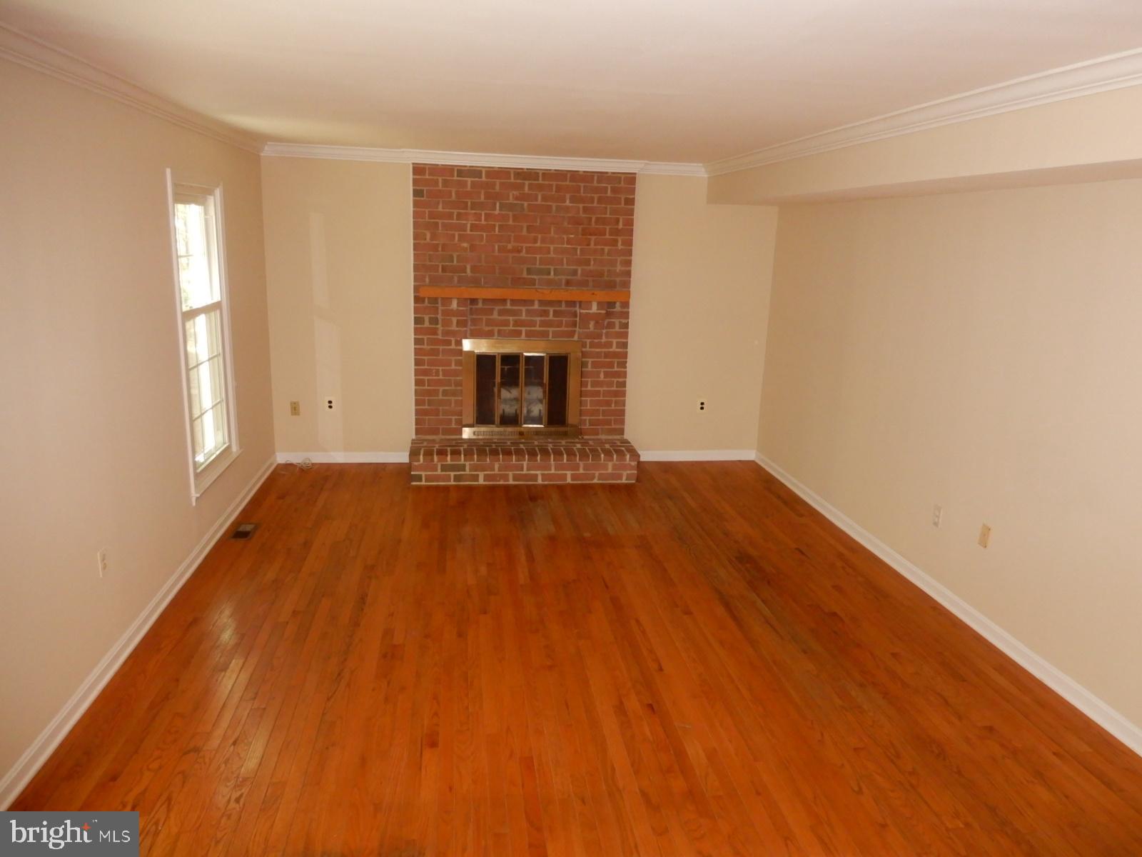 7014 Maple Tree Lane Springfield, VA 22152 - Photo 14 of 56 a view of empty room with wooden floor and fireplace