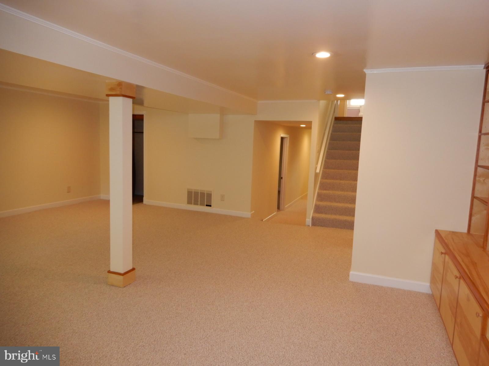 7014 Maple Tree Lane Springfield, VA 22152 - Photo 23 of 56 a view of a hallway with wooden floor