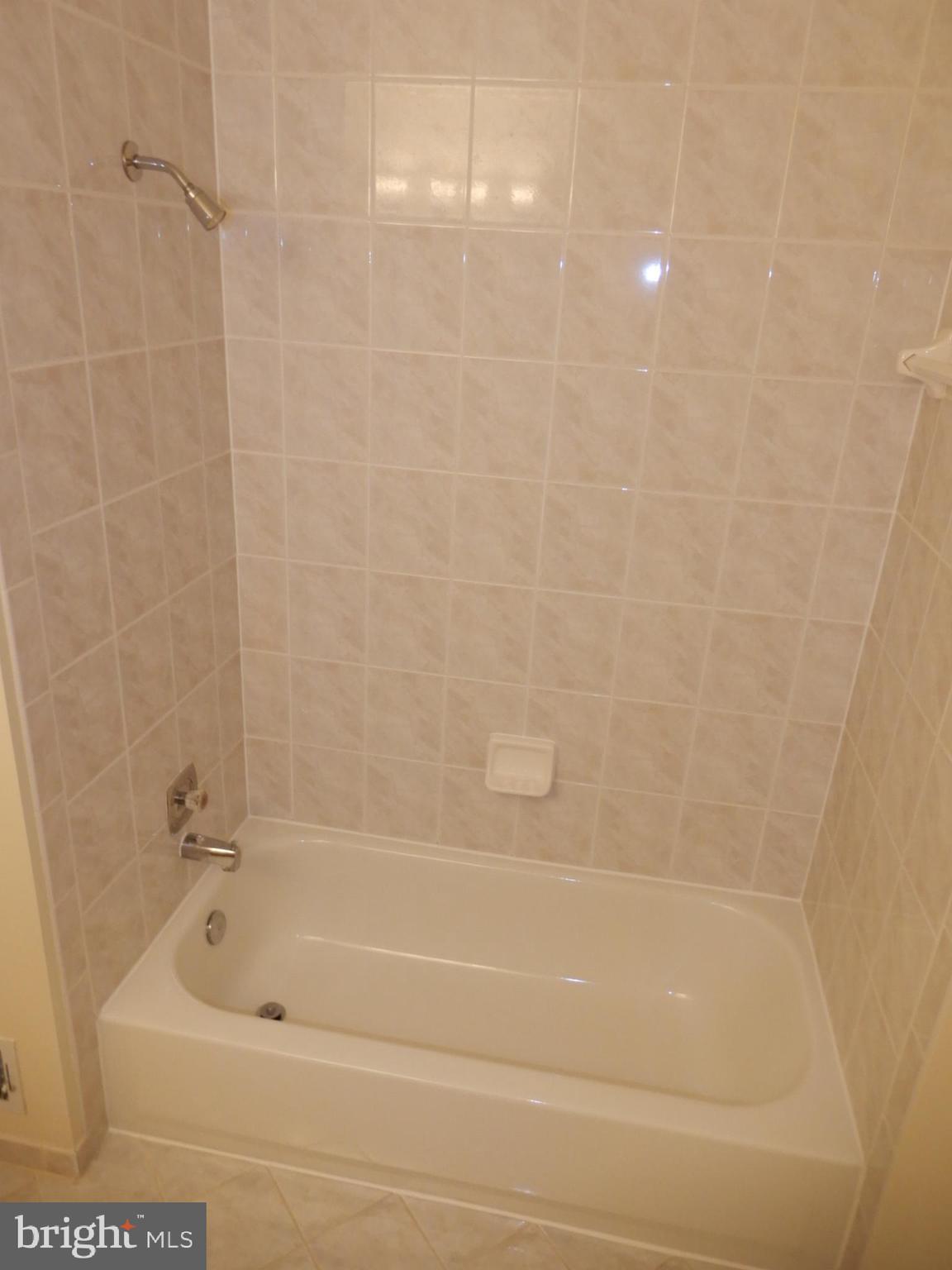 7014 Maple Tree Lane Springfield, VA 22152 - Photo 37 of 56 a bathroom with a bathtub