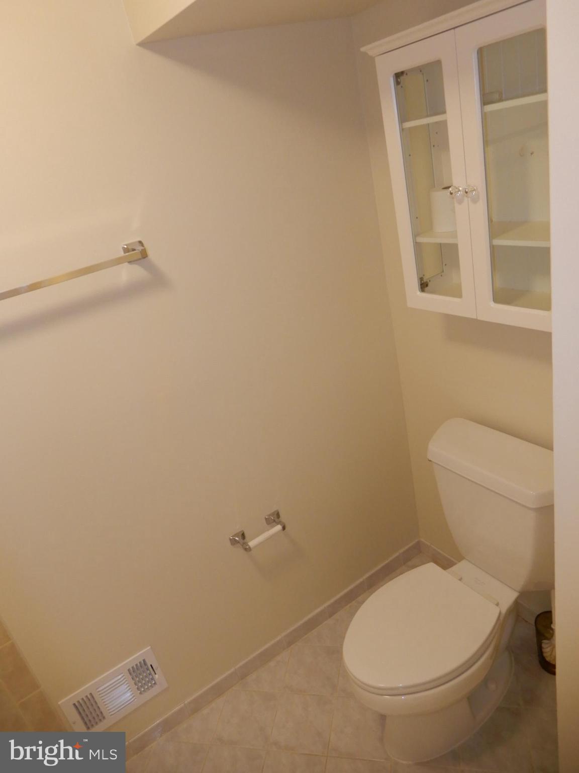 7014 Maple Tree Lane Springfield, VA 22152 - Photo 46 of 56 a white toilet sitting next to a bathroom sink