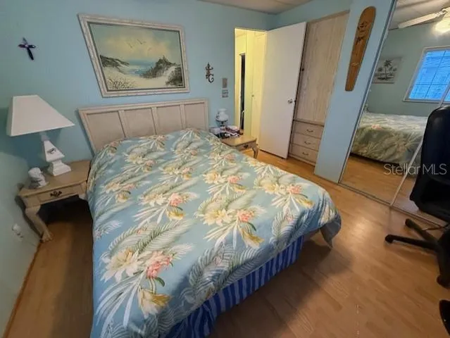 a bedroom with a bed and a mirror