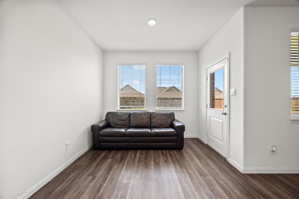753 Lombard Lane Forney, TX 75126 - Photo 11 of 25 Living room featuring dark wood-style floors and baseboards