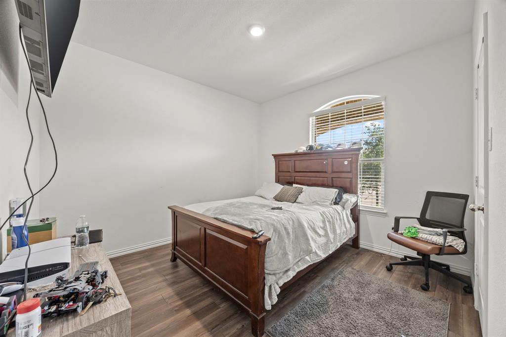 753 Lombard Lane Forney, TX 75126 - Photo 12 of 25 Bedroom featuring dark wood finished floors and baseboards