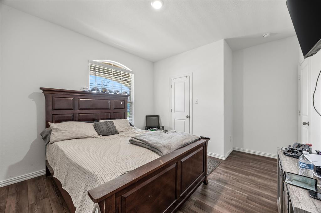 753 Lombard Lane Forney, TX 75126 - Photo 13 of 25 Bedroom featuring baseboards and dark wood-style flooring