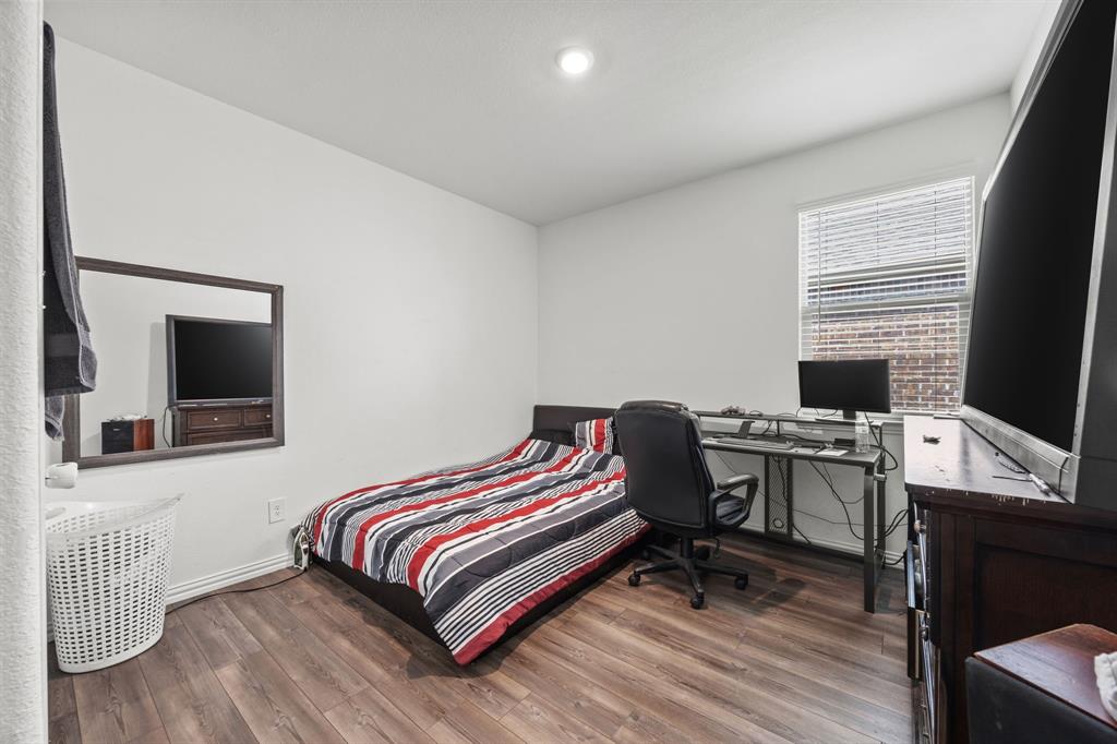 753 Lombard Lane Forney, TX 75126 - Photo 18 of 25 Bedroom featuring wood finished floors and baseboards