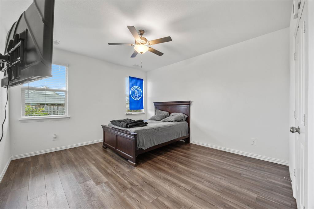 753 Lombard Lane Forney, TX 75126 - Photo 19 of 25 Bedroom featuring wood finished floors and a ceiling fan