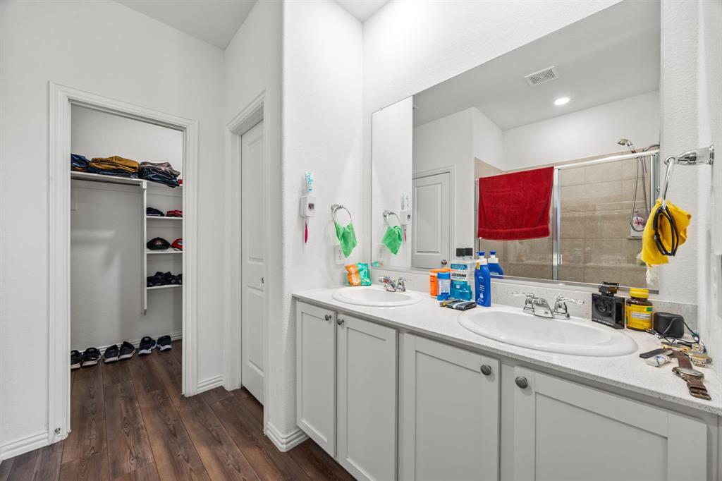 753 Lombard Lane Forney, TX 75126 - Photo 21 of 25 Full bath featuring double vanity, a stall shower, a walk in closet, and wood-type flooring
