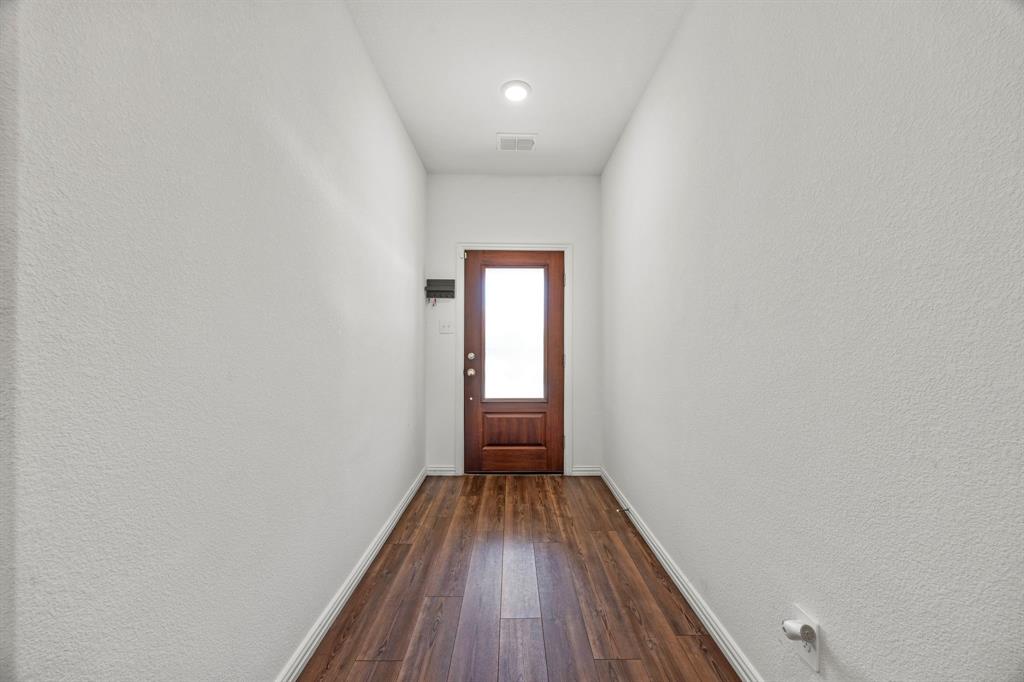 753 Lombard Lane Forney, TX 75126 - Photo 4 of 25 Entryway with dark wood-style floors and baseboards