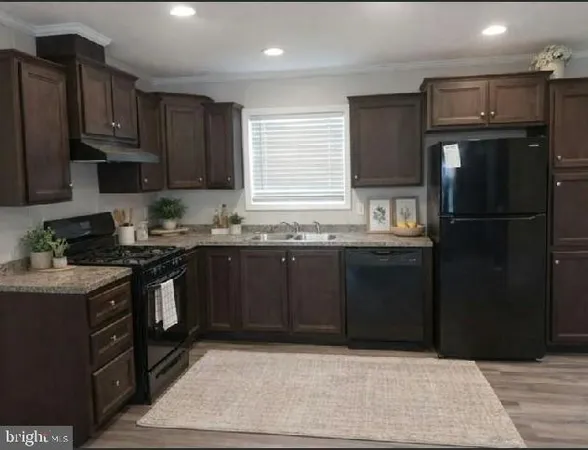 a kitchen with a sink stove and refrigerator