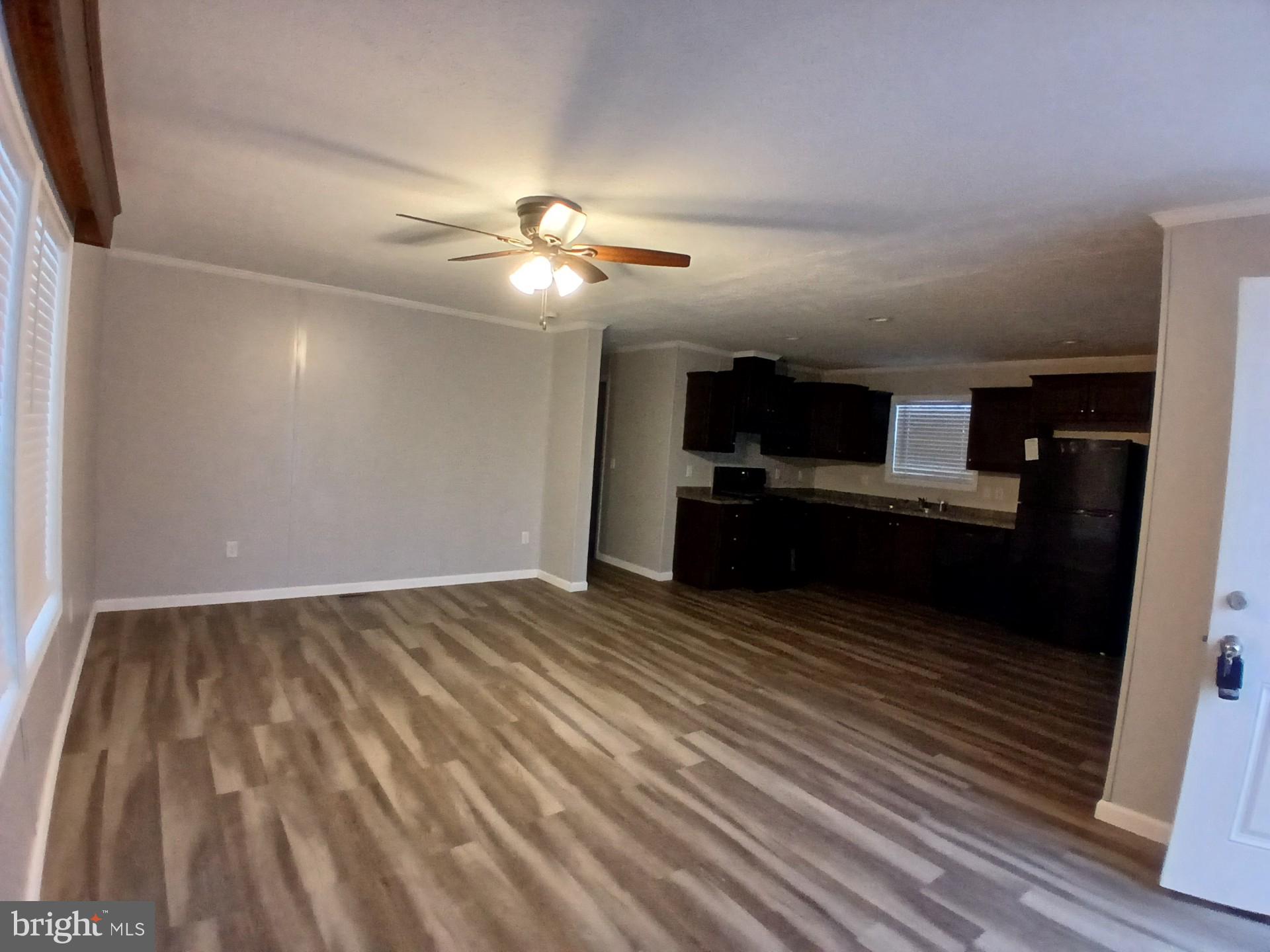 868 East Commerce Street Bridgeton, NJ 08302 - Photo 4 of 4 wooden floor in an empty room with a kitchen