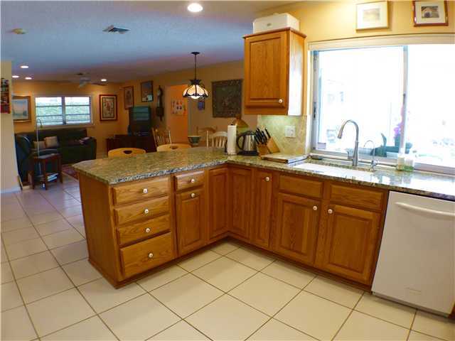 827 Northeast 33rd Street Boca Raton, FL 33431 - Photo 13 of 25 a kitchen with a sink and cabinets