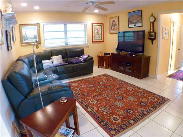 827 Northeast 33rd Street Boca Raton, FL 33431 - Photo 16 of 25 a living room with furniture and a flat screen tv