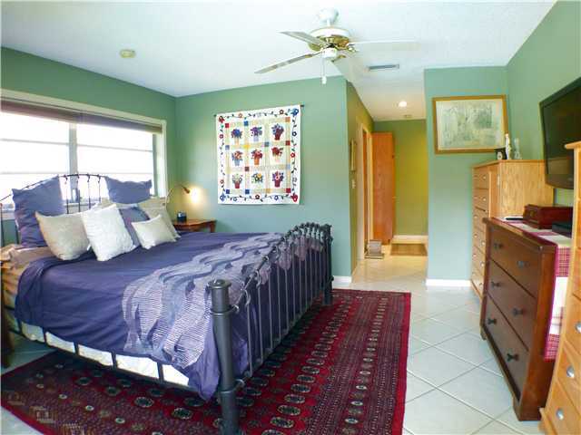 827 Northeast 33rd Street Boca Raton, FL 33431 - Photo 18 of 25 a bedroom with a bed a dresser next to a window