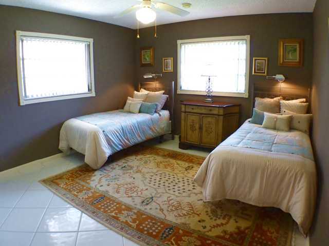 827 Northeast 33rd Street Boca Raton, FL 33431 - Photo 20 of 25 a bedroom with two beds and a window