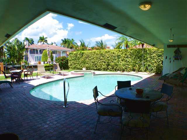 827 Northeast 33rd Street Boca Raton, FL 33431 - Photo 23 of 25 a view of swimming pool with outdoor seating and plants