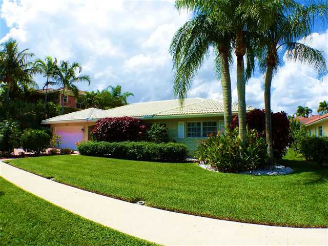 827 Northeast 33rd Street Boca Raton, FL 33431 - Photo 3 of 25 a front view of house with a garden