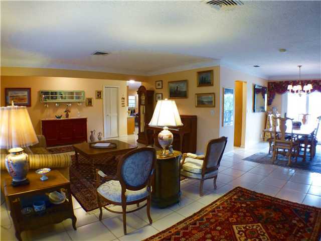 827 Northeast 33rd Street Boca Raton, FL 33431 - Photo 6 of 25 a living room with furniture a rug and a large window