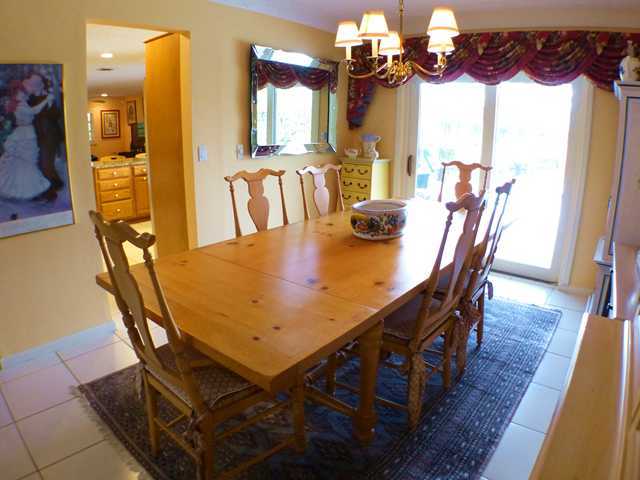 827 Northeast 33rd Street Boca Raton, FL 33431 - Photo 8 of 25 a view of a dining room with furniture and wooden floor