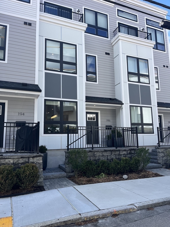 17-31 Charles Park Road, Unit 196 Boston, MA 02132 - Photo 25 of 25 a front view of a house with a yard