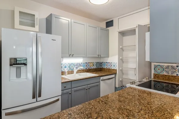 a kitchen with a sink stove and refrigerator