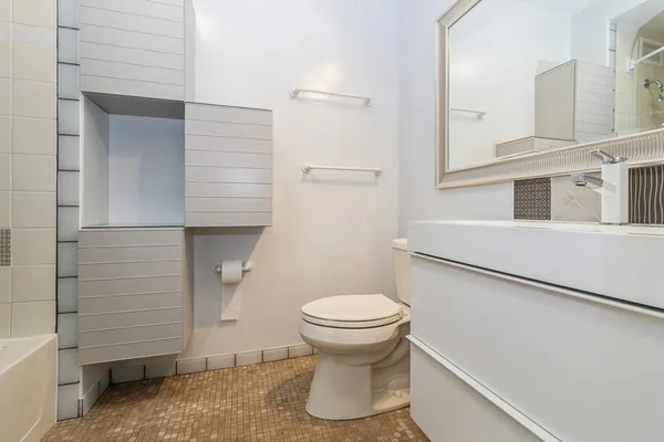 a bathroom with a toilet and a shower