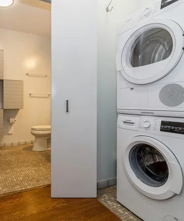 a view of a bedroom with a washer and dryer