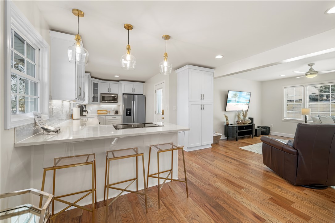 640 Old Salem Road Seneca, SC 29672 - Photo 11 of 32 This inviting space features a kitchen island, hardwood flooring, and abundant natural light.