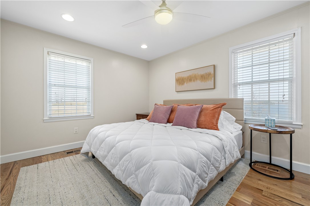 640 Old Salem Road Seneca, SC 29672 - Photo 12 of 32 This inviting bedroom features rich hardwood flooring and abundant natural light, creating a serene personal retreat.