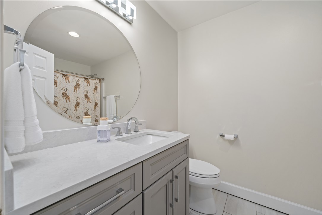 640 Old Salem Road Seneca, SC 29672 - Photo 16 of 32 This clean and bright bathroom features a modern vanity with a large circular mirror.