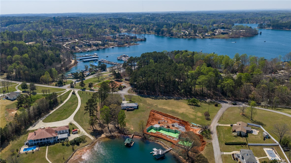 640 Old Salem Road Seneca, SC 29672 - Photo 27 of 32 This aerial view showcases a vibrant community nestled by a serene lake, featuring diverse properties and boat docks.