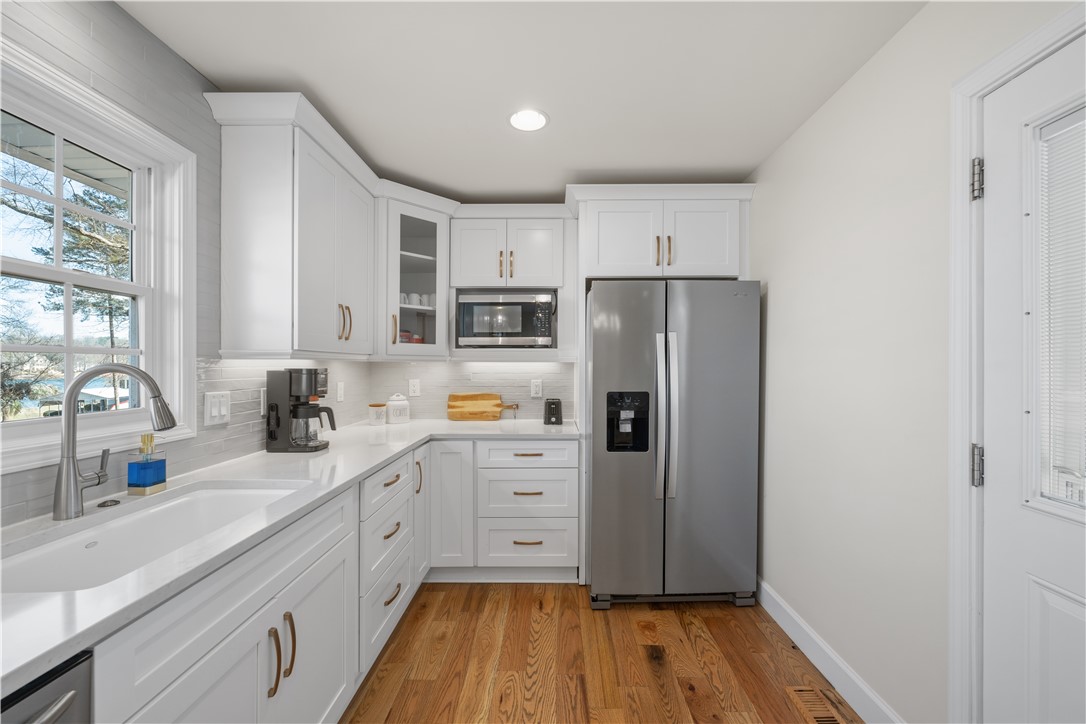 640 Old Salem Road Seneca, SC 29672 - Photo 9 of 32 This bright kitchen features ample counter space, modern appliances, and warm wood flooring.