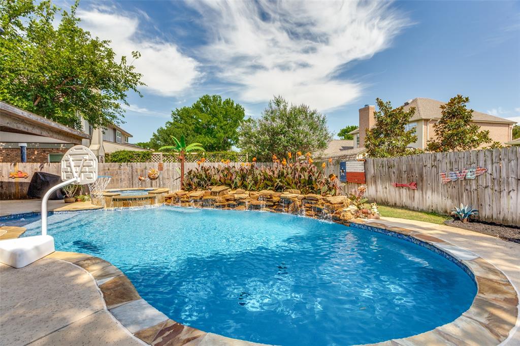 1228 Concho Drive Benbrook, TX 76126 - Photo 33 of 39 Freeform swimming pool with integrated spa and rock waterfall feature