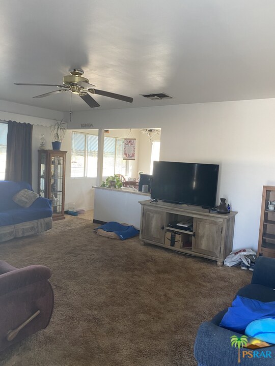 6638 Outpost Road Joshua Tree, CA 92252 - Photo 9 of 11 a living room with furniture and a flat screen tv