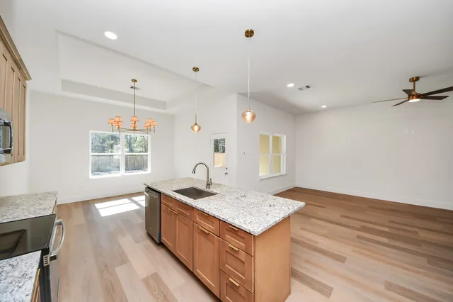 a kitchen with a sink stove and wooden cabinets