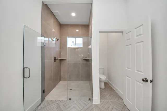 a bathroom with a shower and toilet