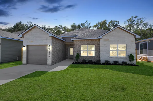 a view of a house with a yard and garage