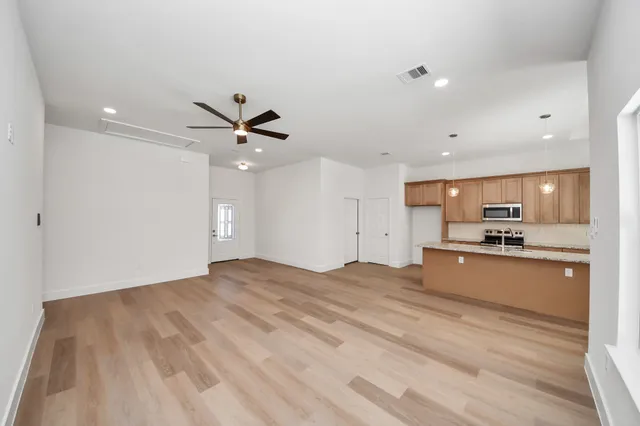 a view of kitchen with sink and wooden floor